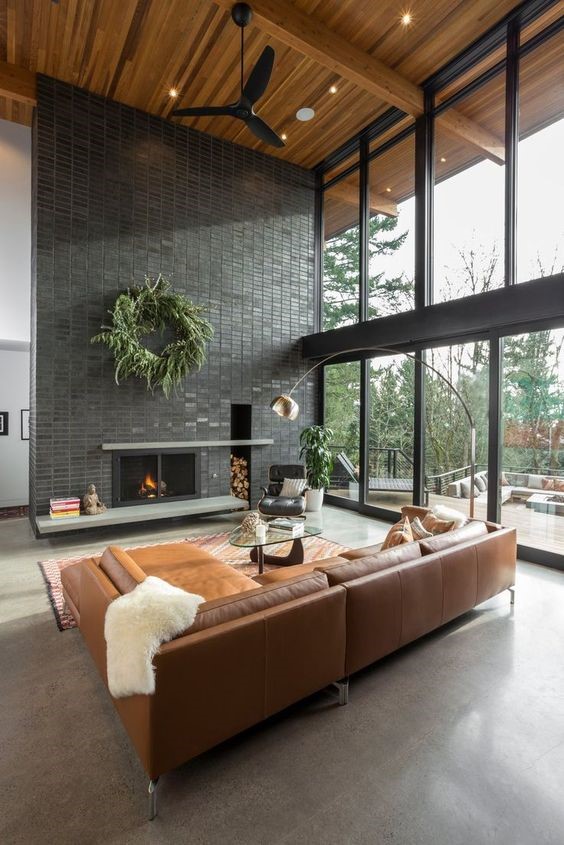 Living room Tagged: Living Room, Accent Lighting, Concrete Floor, Standard Layout Fireplace, Ceiling Lighting, Sectional, Chair, Floor Lighting, Recessed Lighting, Wood Burning Fireplace, and Coffee Tables. The Greenhills House by Craig Wollen